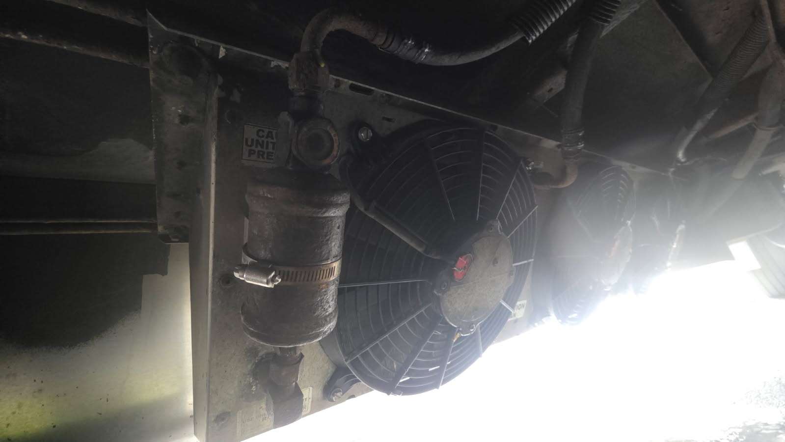 Truck A/C condenser and fan behind the grille