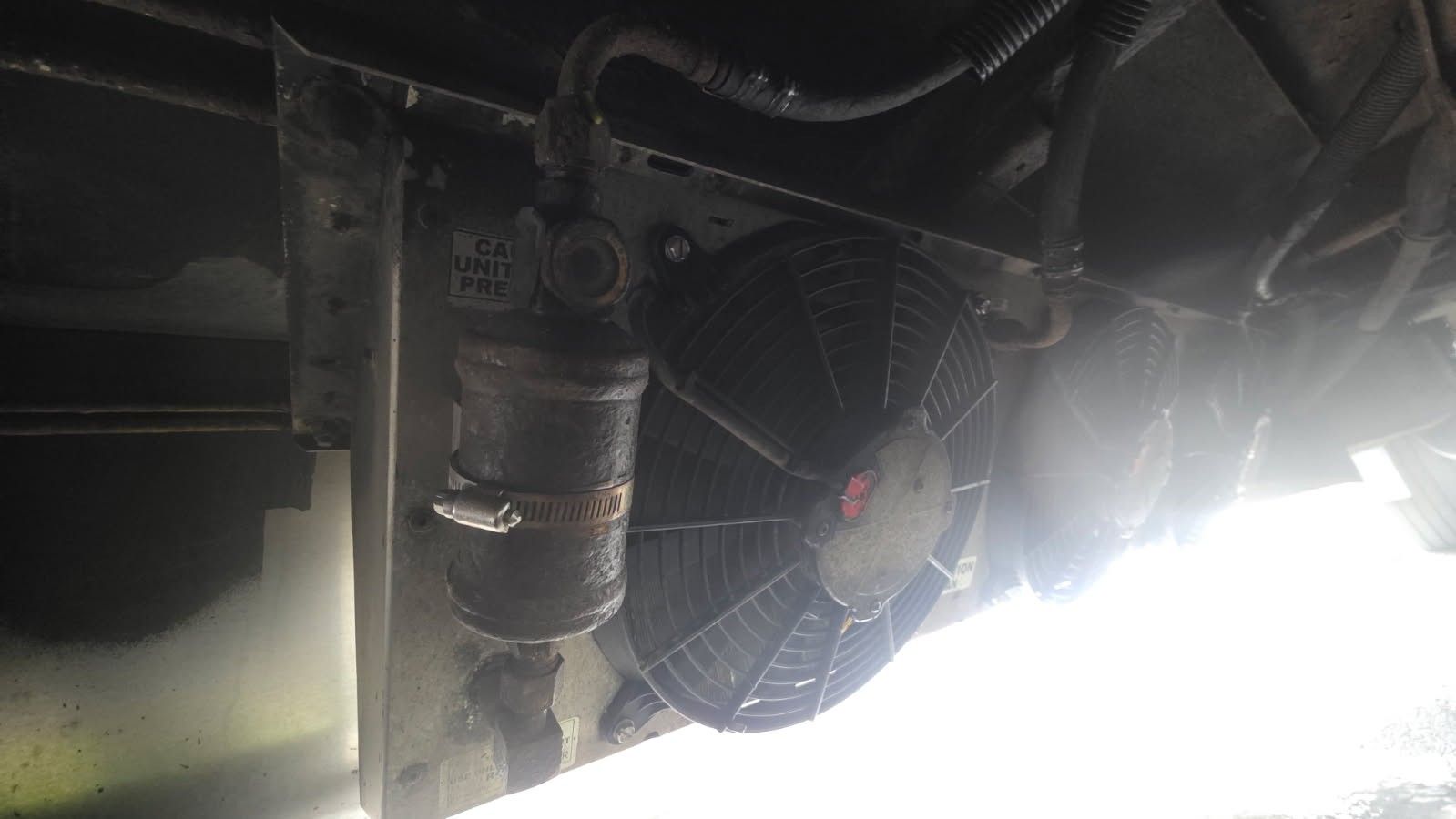 Truck A/C condenser and fan behind the grille