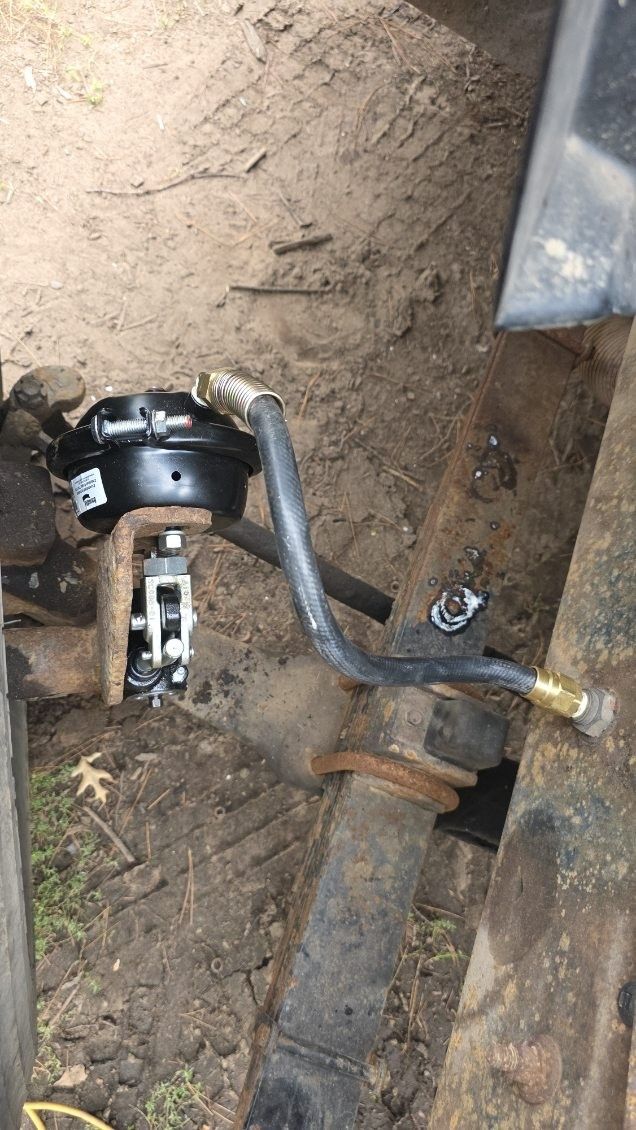 Air brake chamber and slack adjuster being replaced