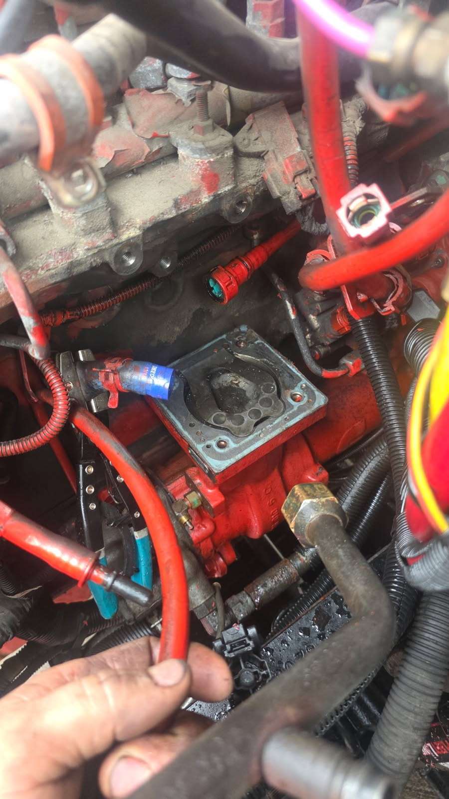 Mechanic working on a diesel engine fuel system on-site