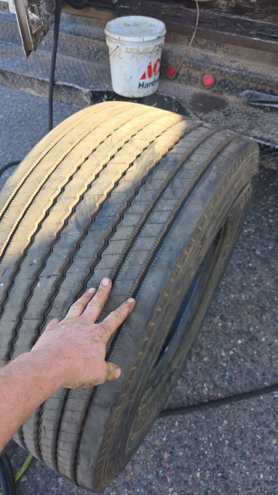 Mechanic checking a worn steer tire