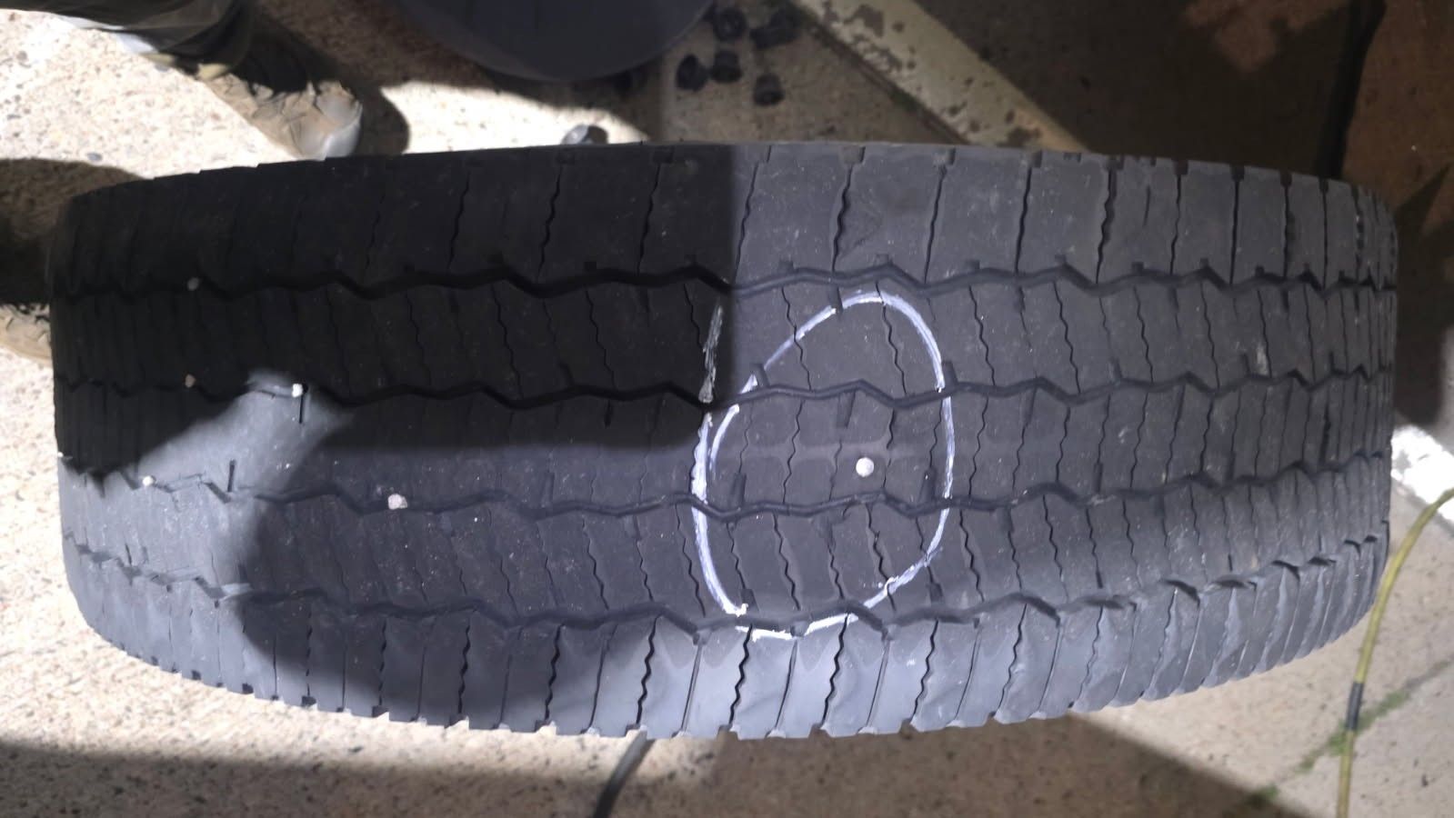 Truck tire with the puncture marked before repair