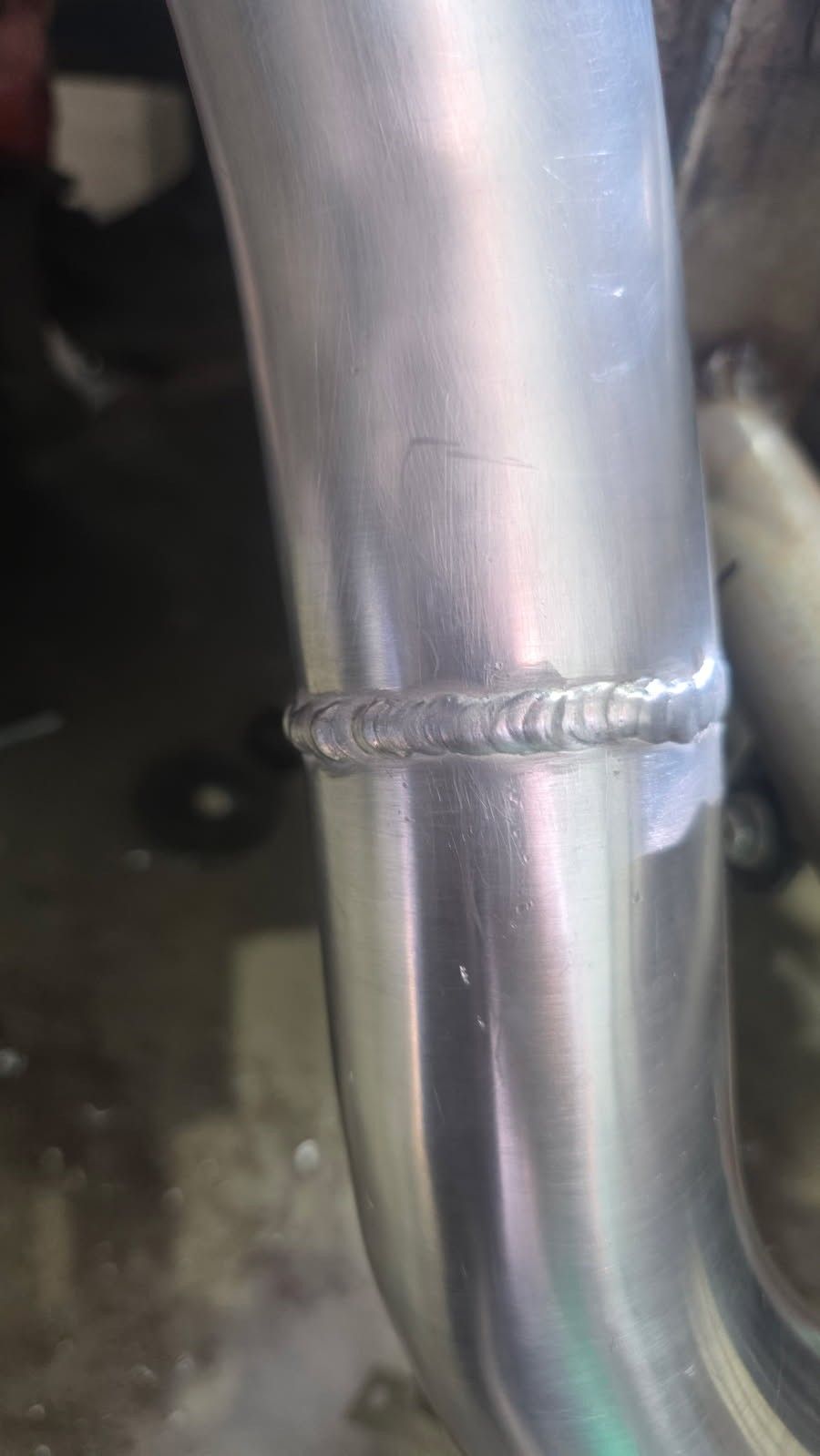 Fresh weld on a stainless truck exhaust pipe