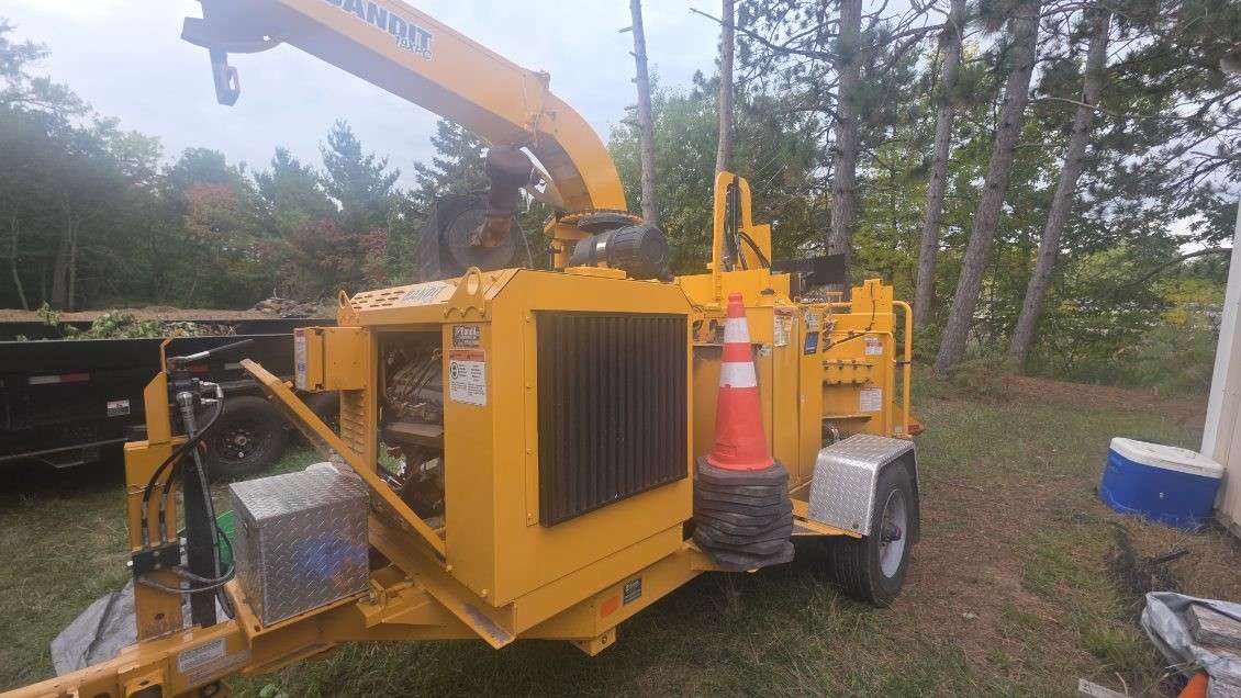 Commercial wood chipper serviced on a job site for hydraulic repair